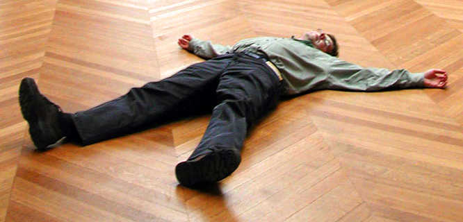 Rick Steves sprawled on the floor of the Louvre